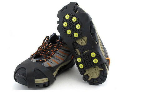 Studded ice grips on grey hiking shoes, seen from the side and from below; shoes not included